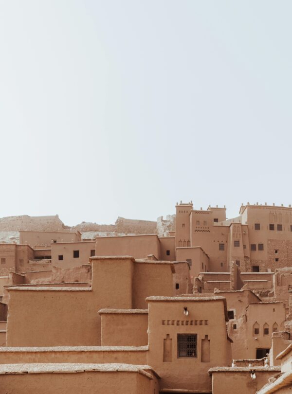 Explore the historic traditional mud-brick architecture of Ait Ben Haddou Kasbah under a clear sky.
