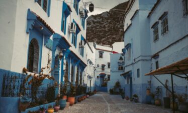 Explore the iconic blue alleyways and potted plants of Chefchaouen, Morocco's blue city.